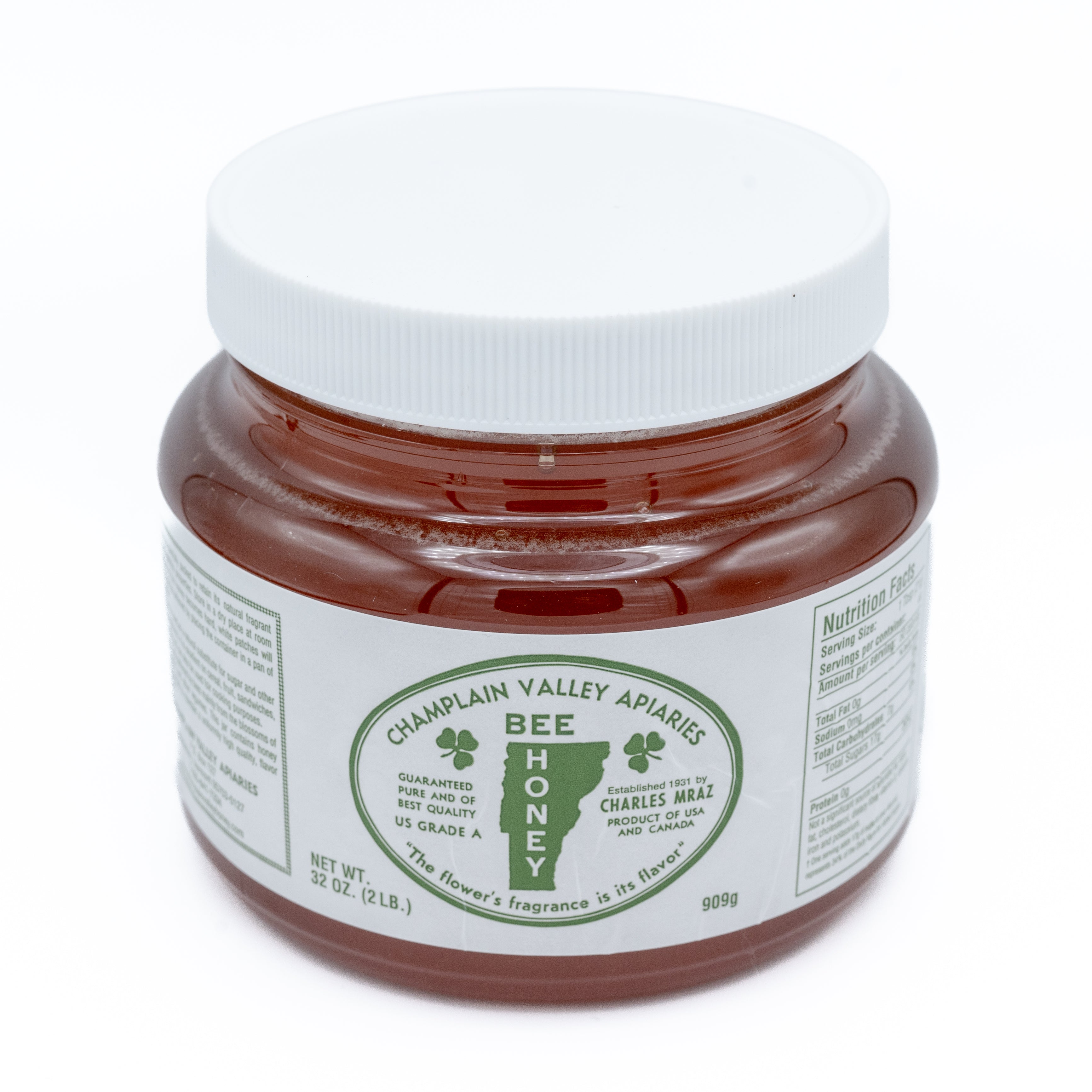 2 Pound jar of champlain valley apiaries honey on a white background